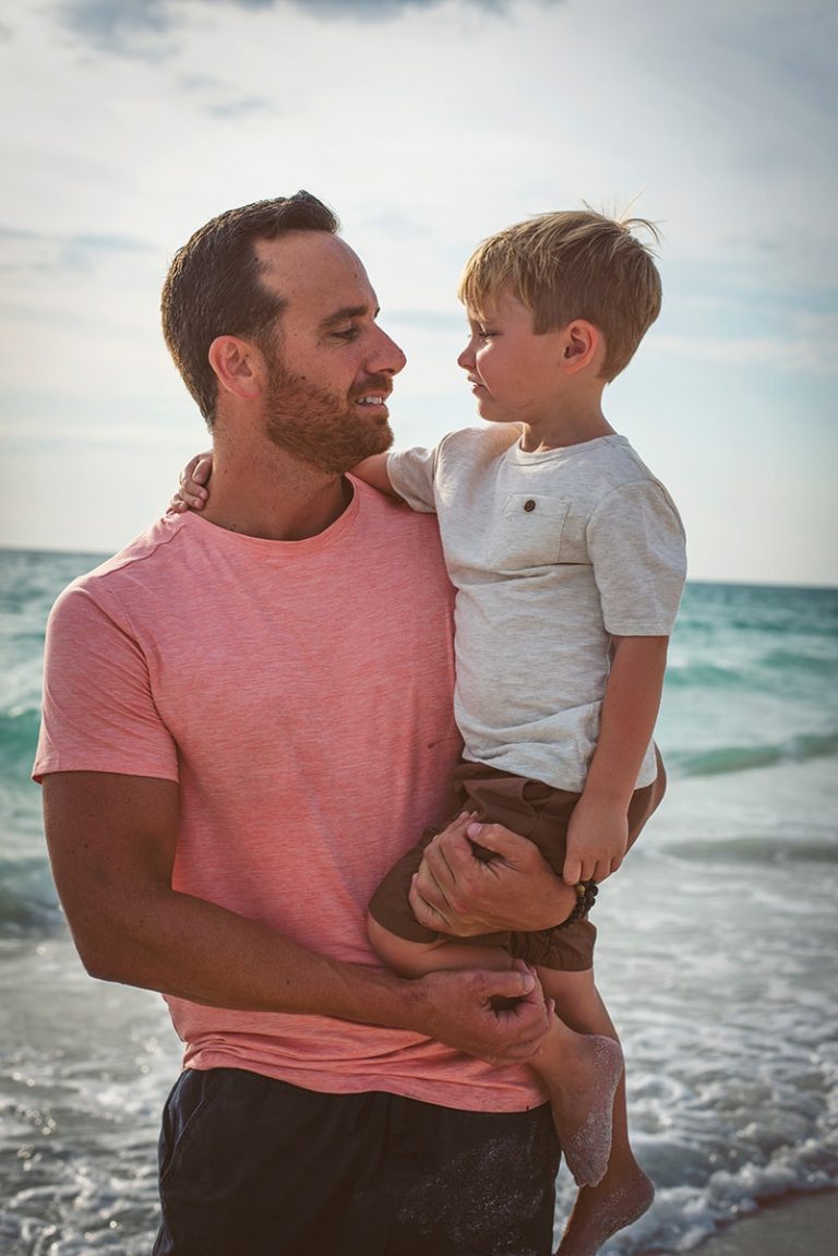 A father and son looking at each other fondly