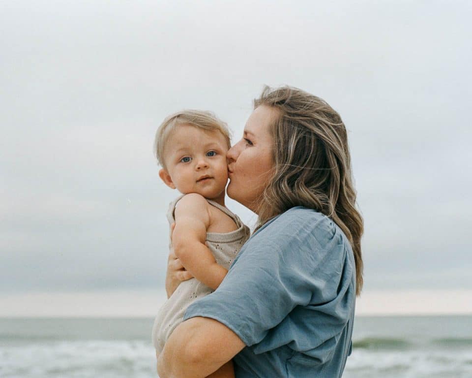 Jinny - Women Kissing Baby on Beach